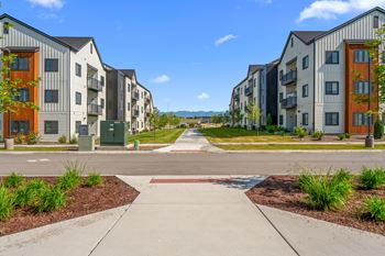 A row of modern apartment buildings with a sidewalk in front. at Silverbrook Apartments, Montana, 59901
