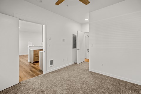A room with a carpeted floor and a ceiling fan at Silverbrook Apartments, Montana