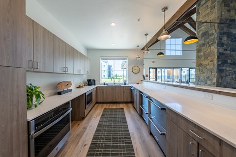 A modern kitchen with wooden cabinets and black appliances. at Silverbrook Apartments, Kalispell
