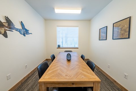 A conference room with a long table and chairs. at Silverbrook Apartments, Kalispell, Montana