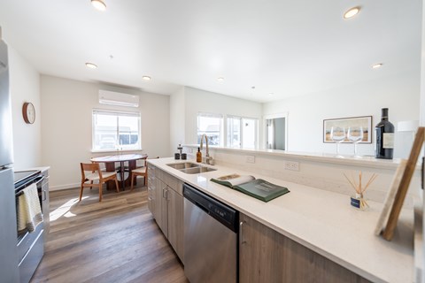 A modern kitchen with a large island and stainless steel appliances. at Silverbrook Apartments, Kalispell