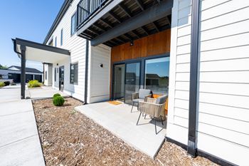 A modern house with a white exterior and a wooden door. at Silverbrook Apartments, Kalispell, Montana