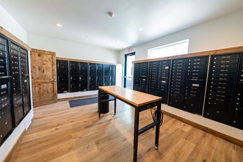 A room with a table and a list of names on the wall. at Silverbrook Apartments, Kalispell, Montana