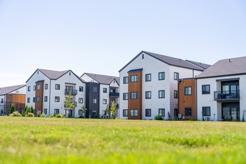 A row of modern townhouses with balconies and multiple windows. at Silverbrook Apartments, Kalispell, MT