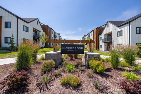 A sign that says Silverbrook Apartments is in front of a building. at Silverbrook Apartments, Kalispell