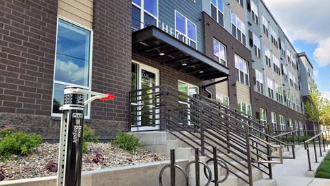 A building with a red arrow pointing to a door.