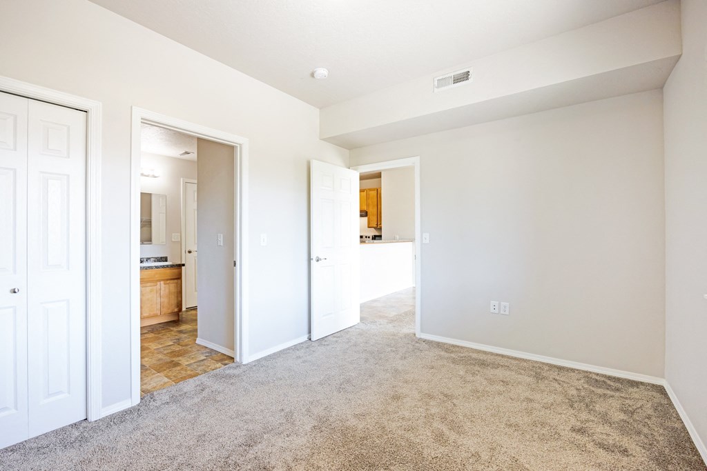 A spacious room with white walls and carpeted floor. at Ashlyn Place, Montana, 59801