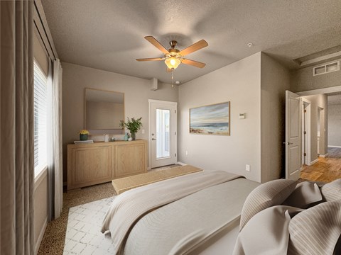 a bedroom with a large bed and a ceiling fan at Southside Townhomes, Nampa, ID