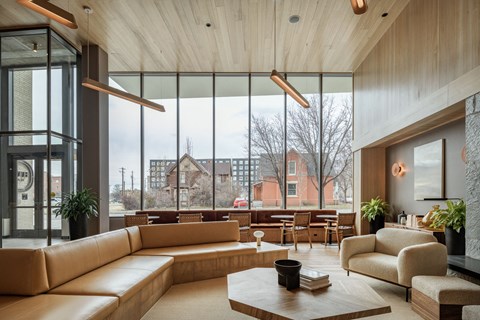 a living room with couches and a coffee table in front of a large window