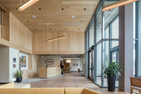 a large lobby with a reception desk and large windows