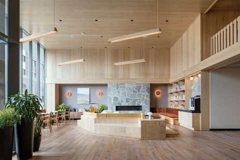a large living room with a stone fireplace and wooden ceilings