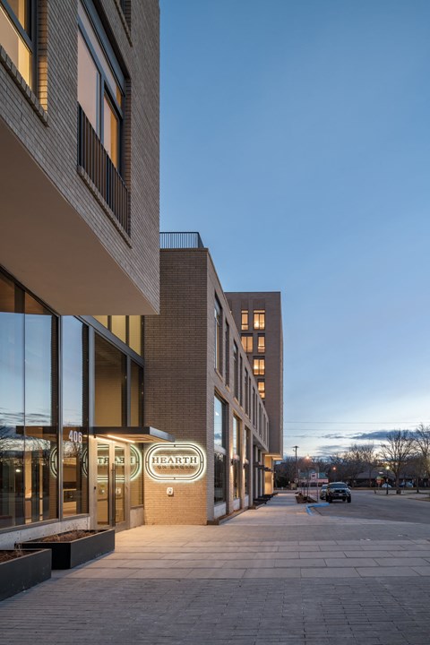 a sidewalk in front of a building with a sign