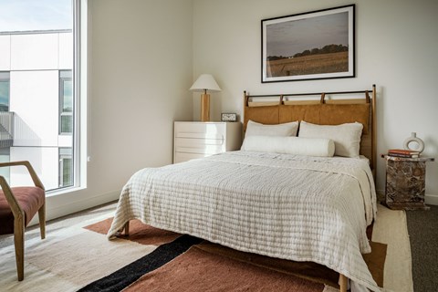 a bedroom with a bed and a large window