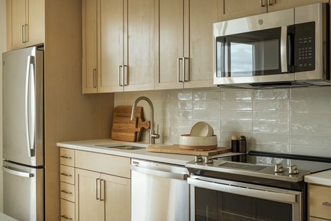 a kitchen with white cabinets and a sink and a microwave