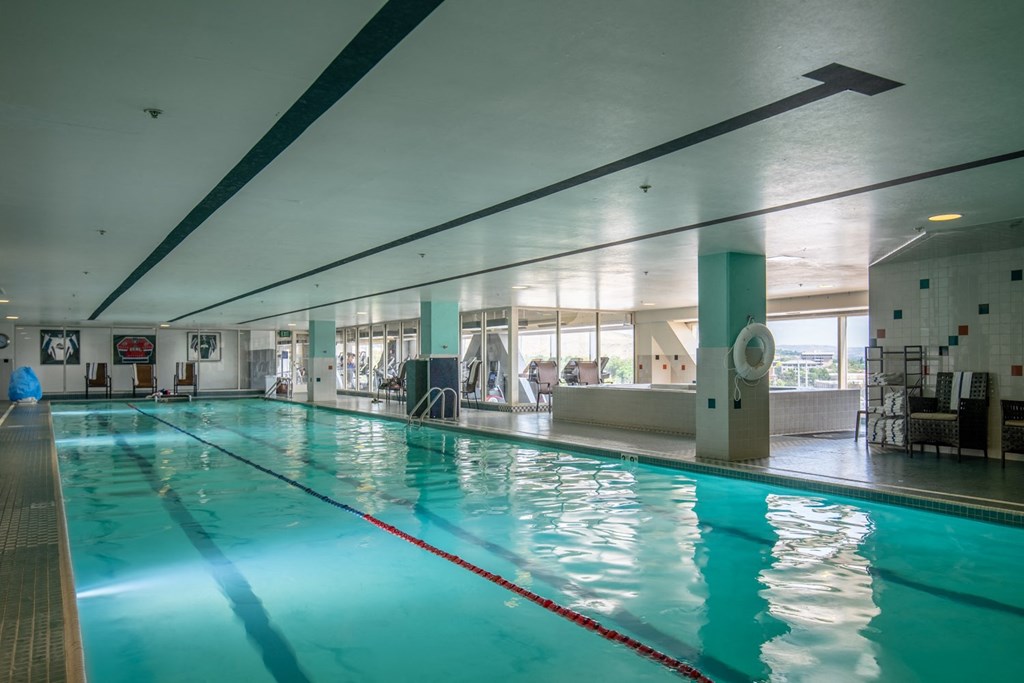 a swimming pool in a gym with a blue water a swimming pool in a gym with a blue water at The Lucy Boise Apartments, Boise