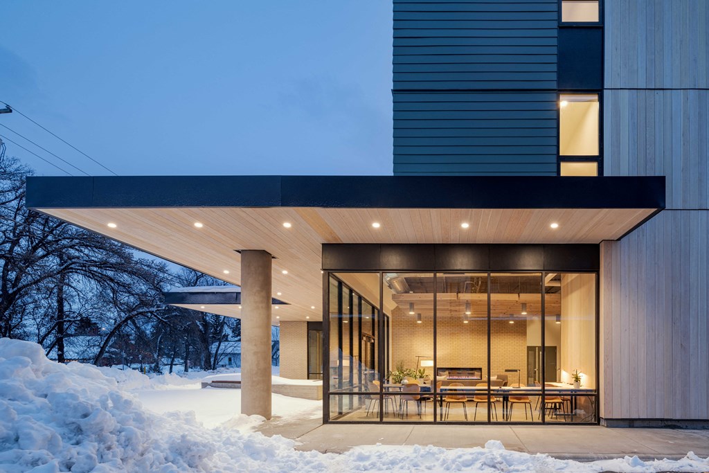 a large glass door opens the dining room to the snow covered yard