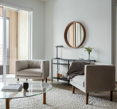 a living room with two chairs and a table
