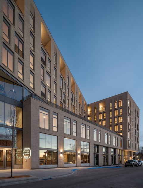 a large brick building on a city street at night