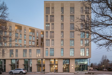 a large brick building with a car parked in front of it