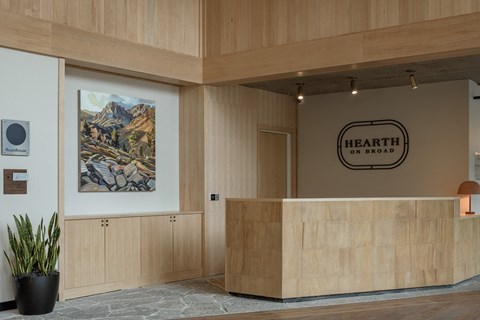 a lobby with a reception desk and a sign for the health on broadway hotel