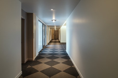 a hallway with a checkered floor in a building