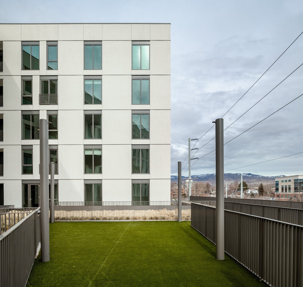 a green lawn in front of a white building