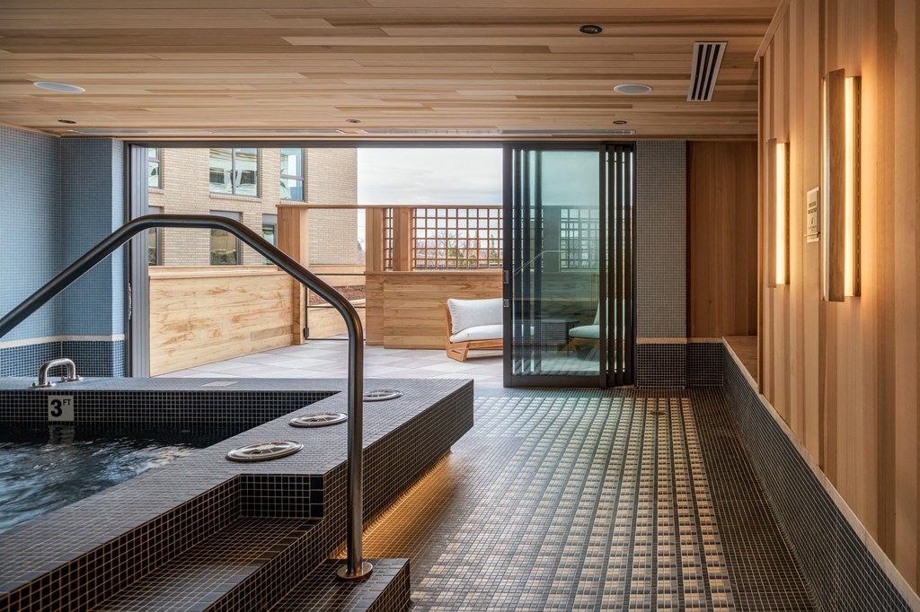 a jacuzzi tub in a bathroom with a sliding glass door