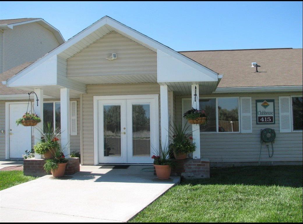 a front porch with potted plants in front of a house