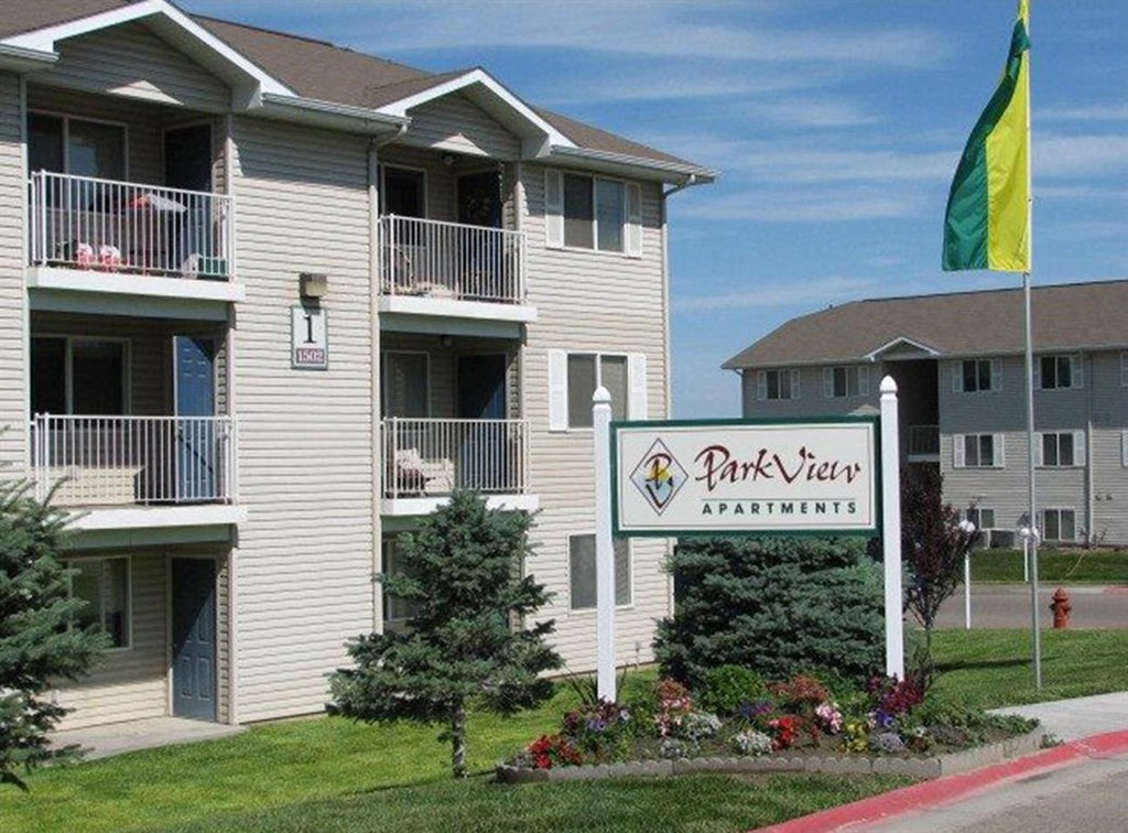 an apartment building with a park view sign in front