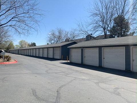 a row of garages with a blue sky in the background