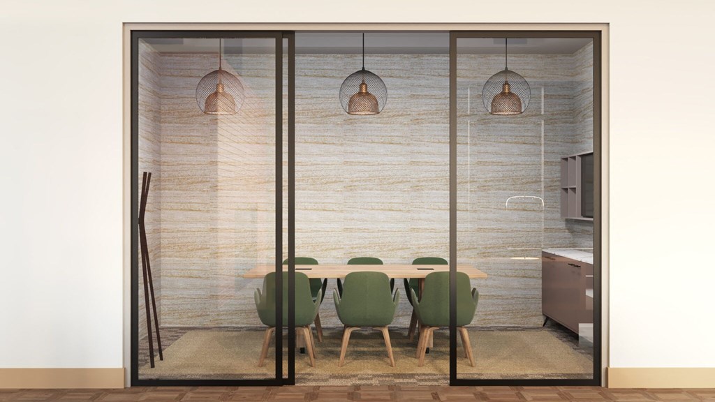 a dining room with a table and chairs and a kitchen in the background