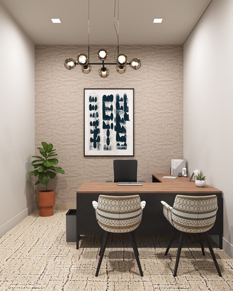 a workspace with two chairs and a desk with a laptop and a painting on the wall