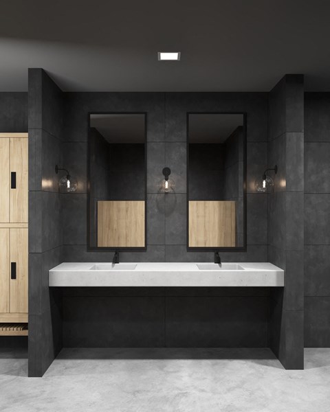 a bathroom with black tile walls and a white sink