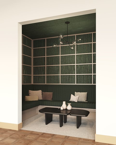 a room with a green wall and a table with two vases on it