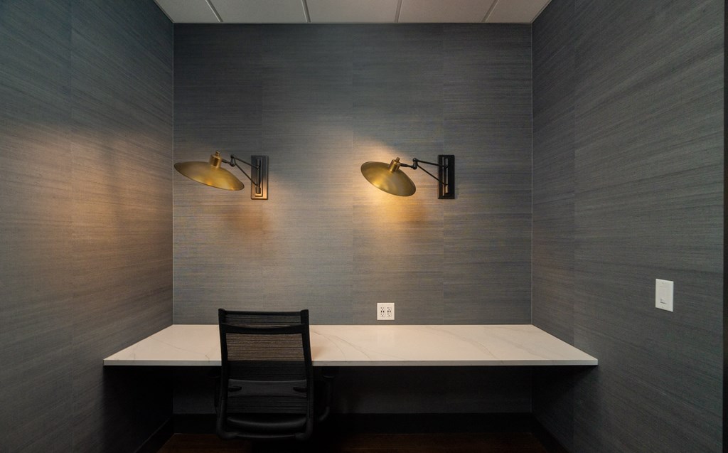 Private resident workspace with built-in desk, two gold wall sconces, and outlets at Sylvan Uptown, Denver, CO, 80203