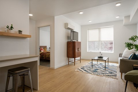 a living room with a couch and a television at The Lucy Boise Apartments, Idaho, 83702