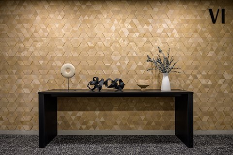 a room with a table and a vase and geometric wall tiles at The Lucy Boise Apartments, Idaho, 83702