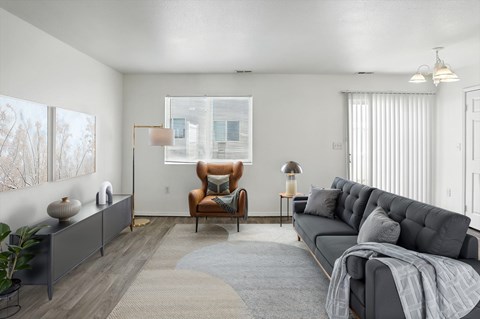 A living room with a grey sofa and a brown armchair.
