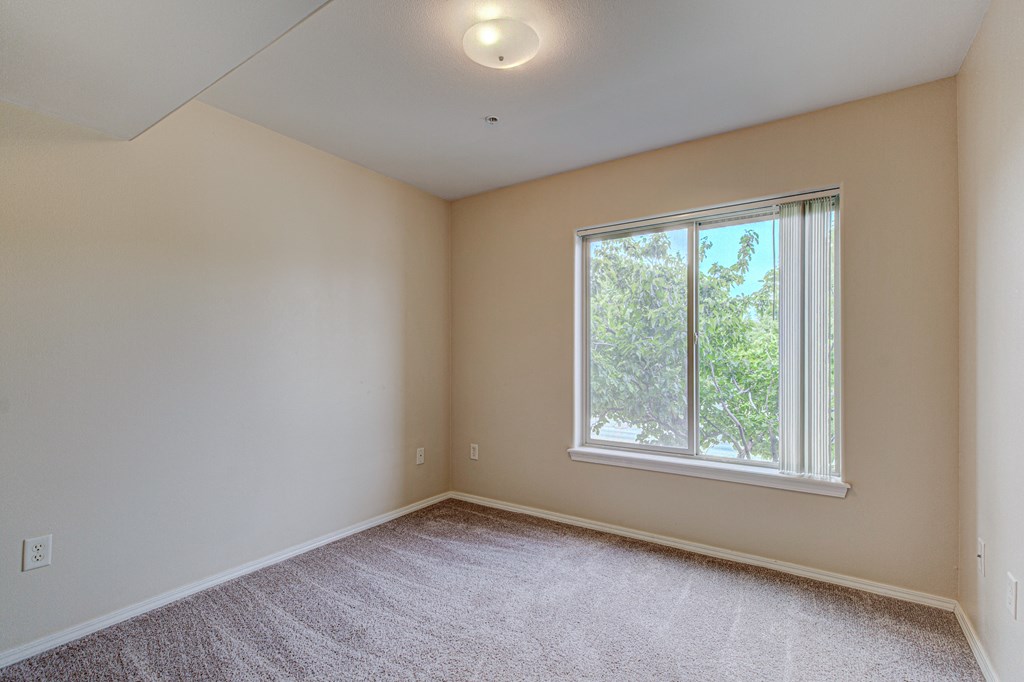 Bedroom with window at River Walk Apartments, Boise