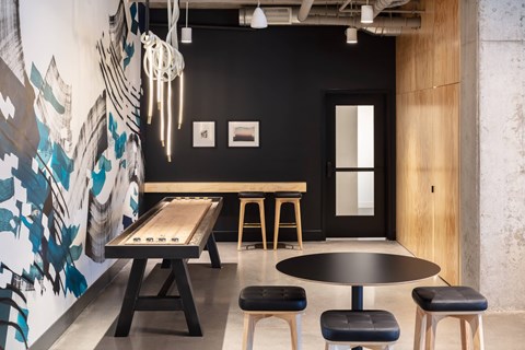A black and white dining room with a wooden table and chairs.