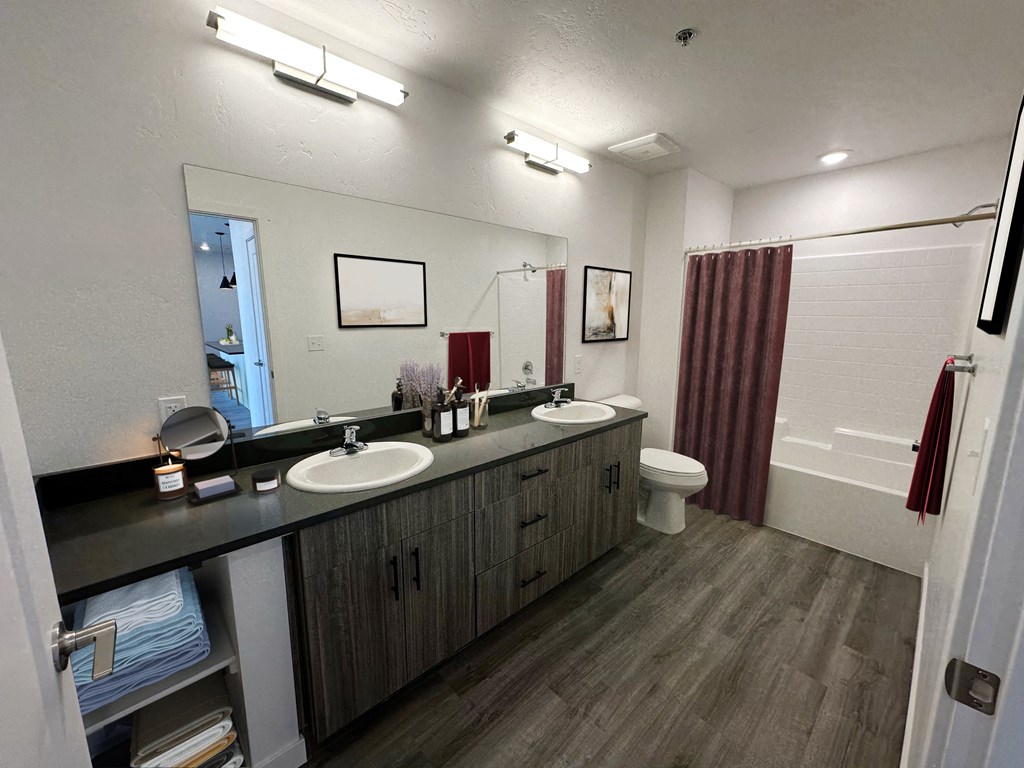 a bathroom with two sinks and a shower and a toilet