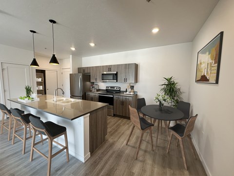 a kitchen and dining area with a table and chairs