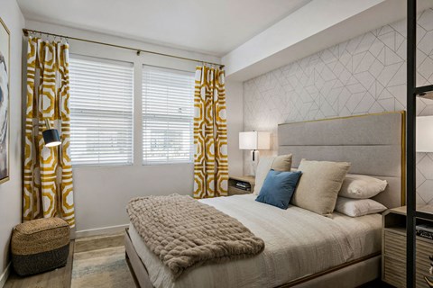 a bedroom with a bed and two windows with curtains  at Seasons at Meridian, Meridian, ID