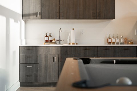 A kitchen with dark wood cabinets and a white backsplash.