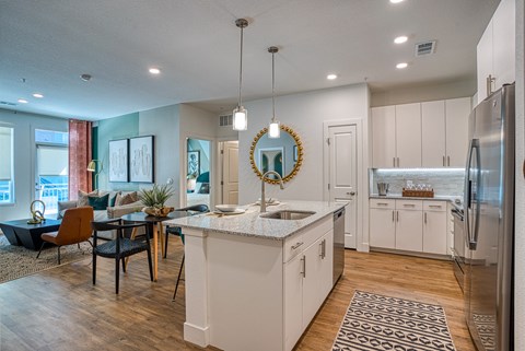 A modern kitchen with a dining table and chairs.