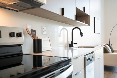 A modern kitchen with a black stove top oven.