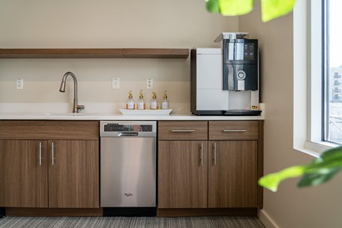 A kitchen with a stainless steel dishwasher and a coffee machine.
