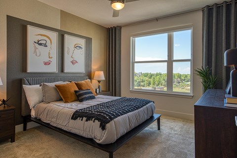 a bedroom with a large bed and a window