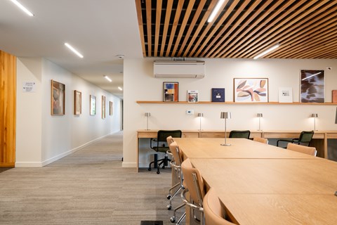 A conference room with a long table and chairs.