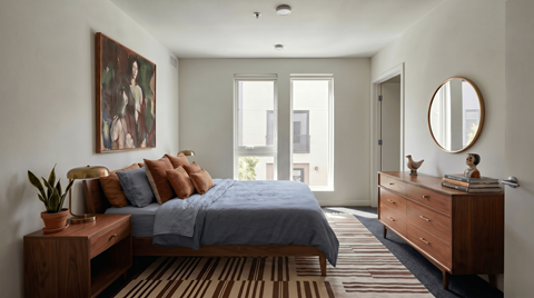 A bedroom with a bed, dresser, and a painting on the wall.